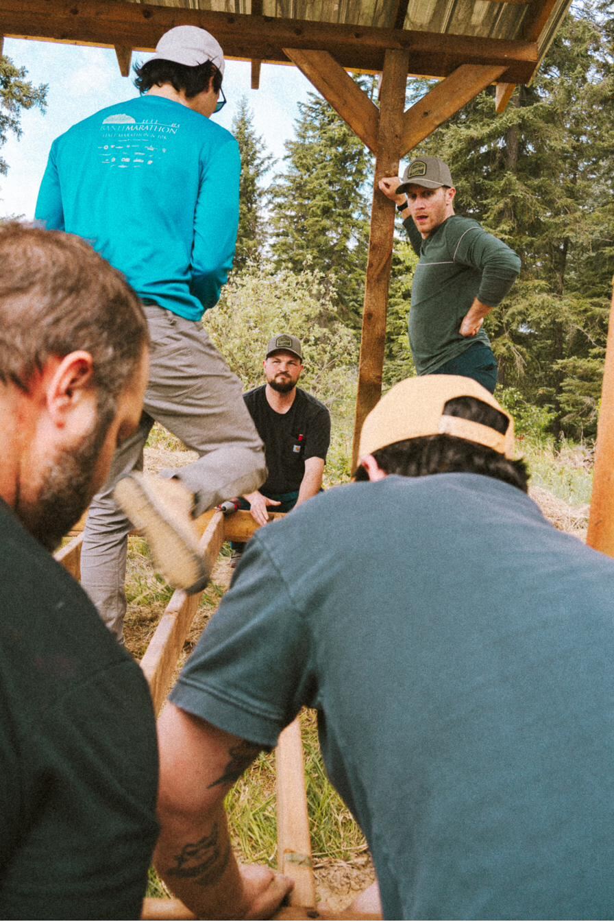 The crew at work raising camp, everyone on tools