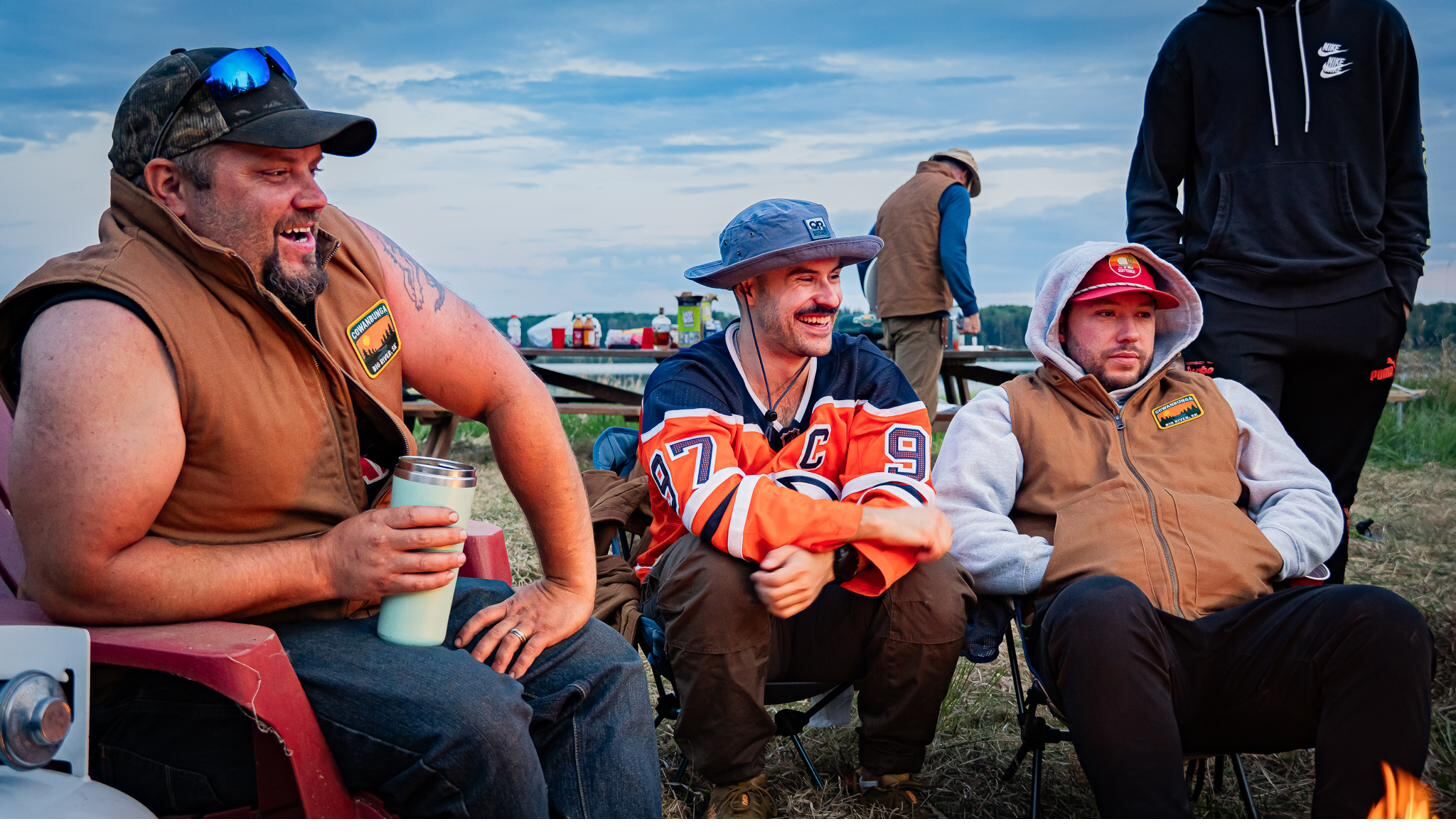 The fellas settled into camp chairs in their canvas vests