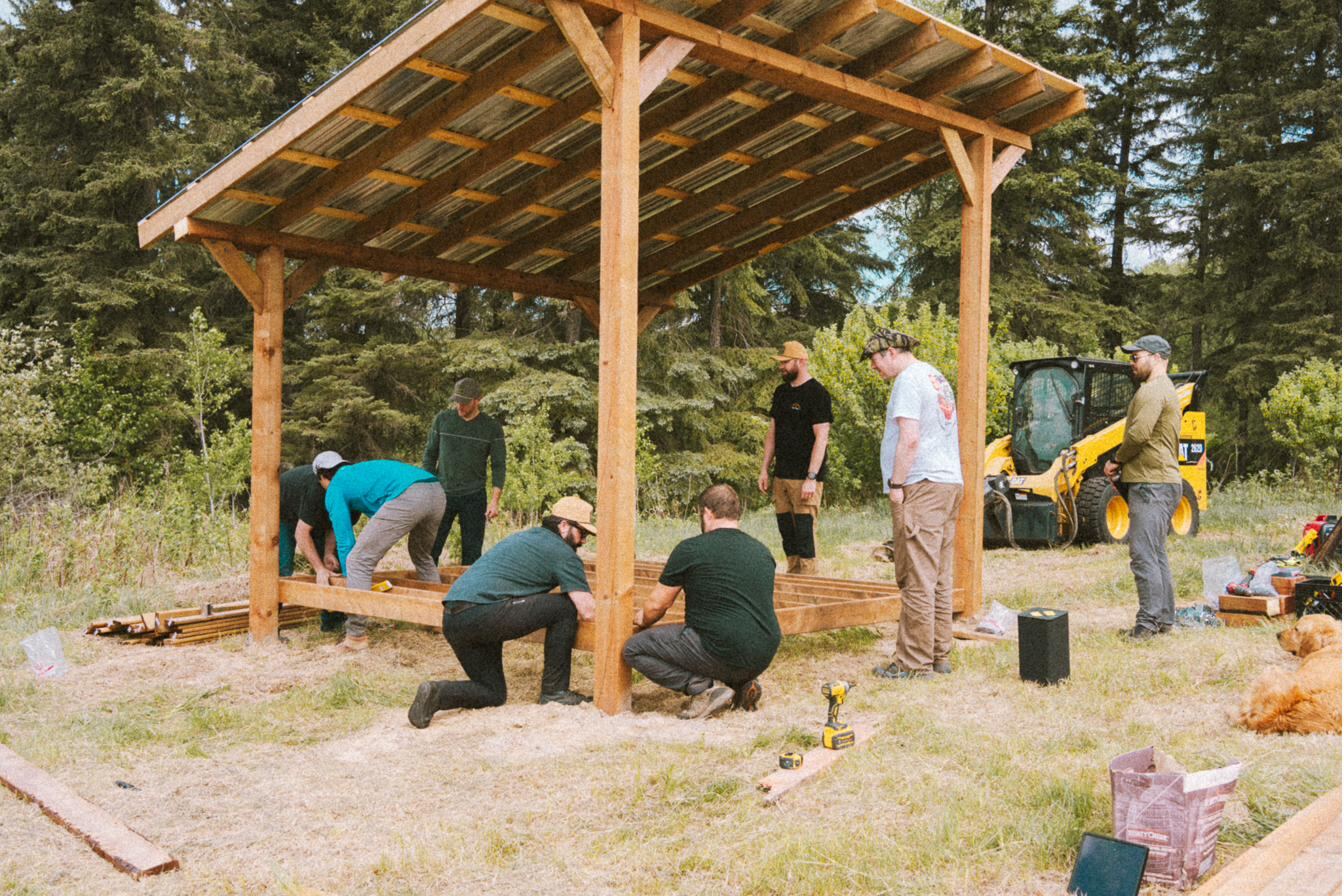 The crew raising the posts of the pole-barn gazebo by the lake
