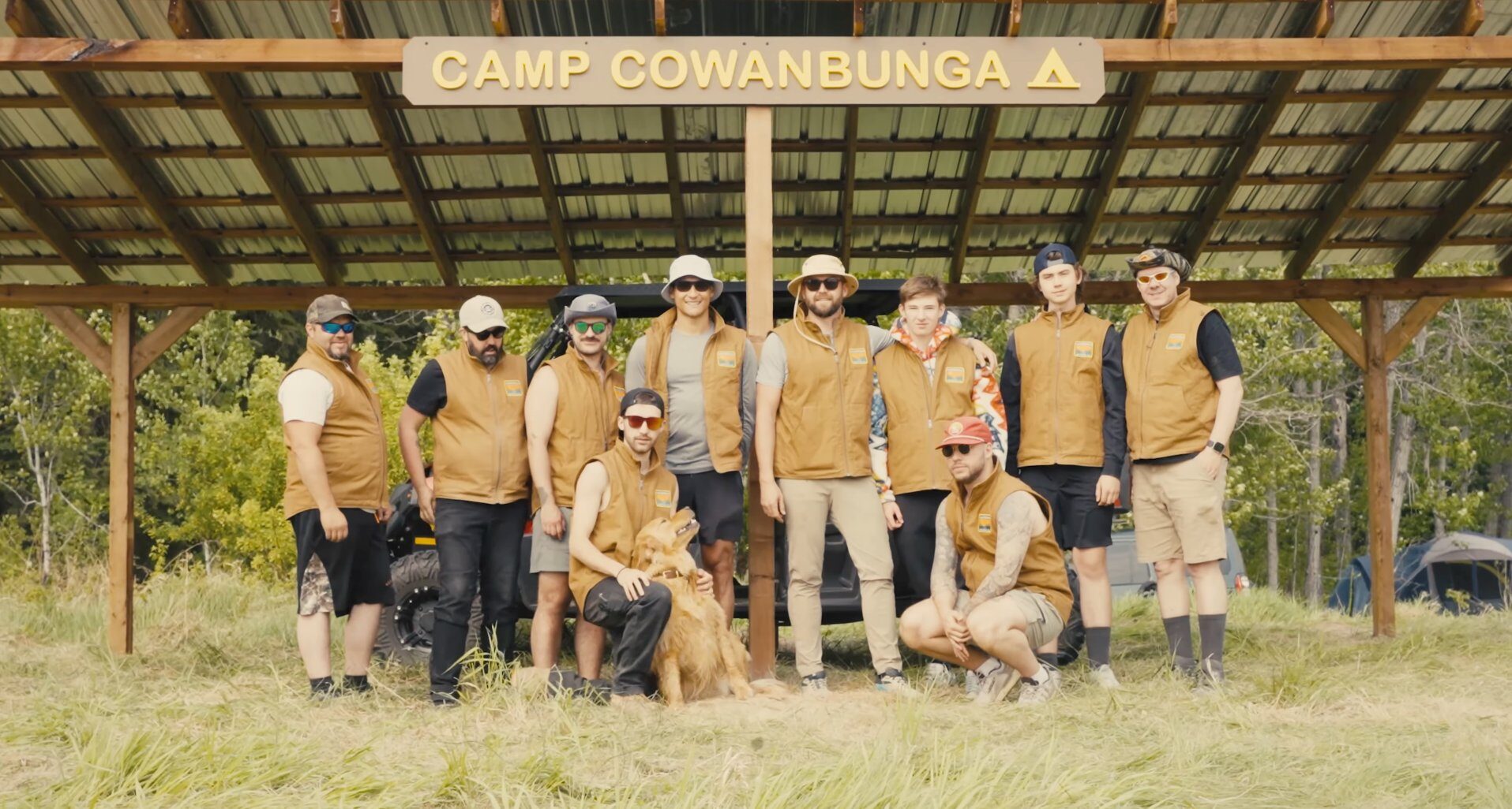 The whole crew lined up beneath the Camp Cowanbunga sign