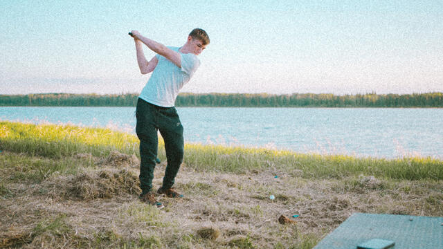 Full swing off the meadow tee, lake beyond