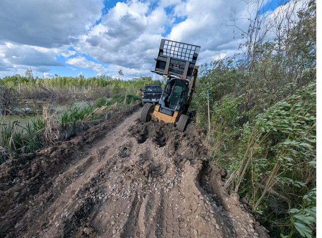 Machinery working through the muddy trail