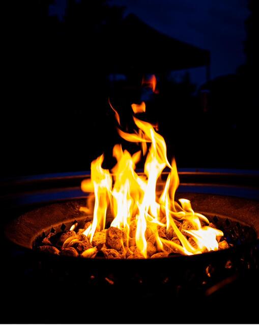 Flames in the fire ring at night