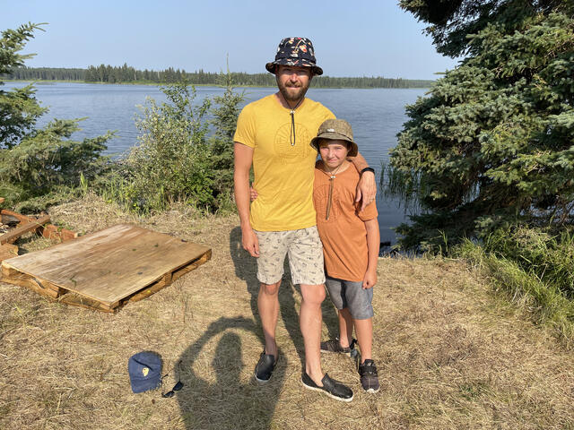 Father and son at the shoreline on his first trip, age twelve