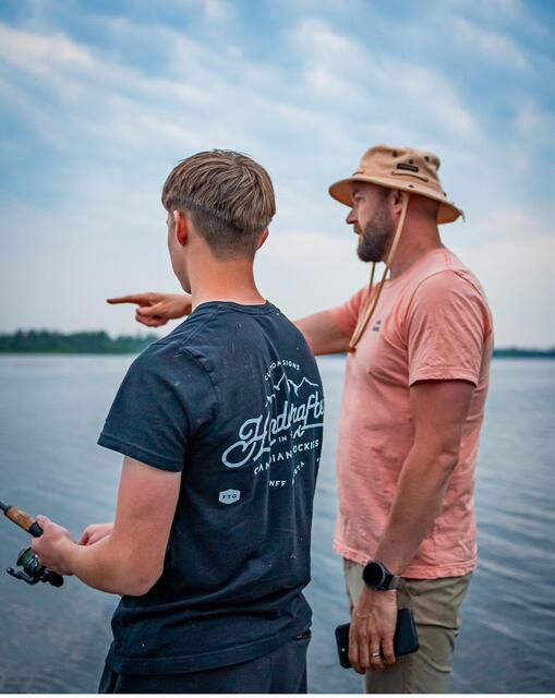 A steady hand pointing out where the fish hold