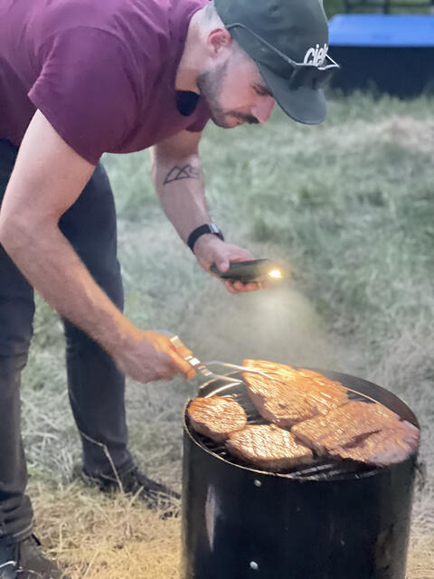 Steaks on the barrel grill by flashlight