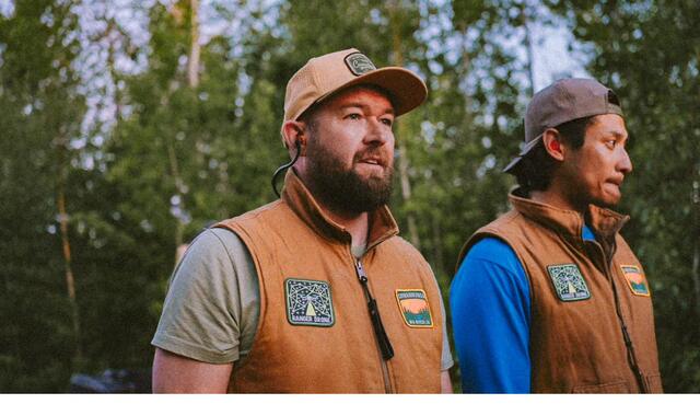 Two fellas in matching canvas vests